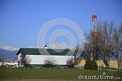 Drilling Rig Oil well green barn with mountains