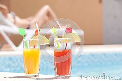 Drinks near the pool with young woman sunbathing i