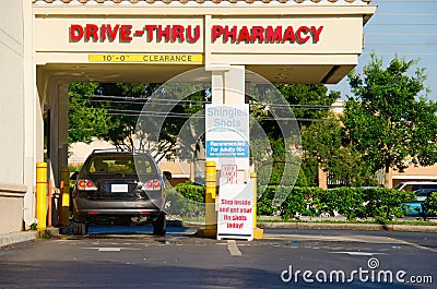 Drive thru pharmacy with a vehicle at the pickup window