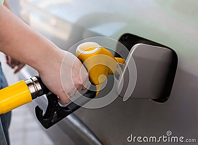 Driver pumping gasoline at the gas station