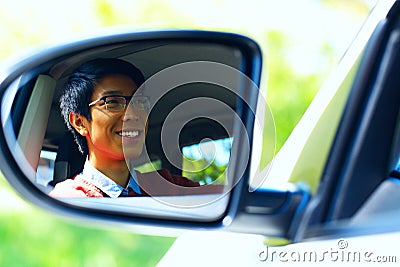 Driver is reflected in mirror of car