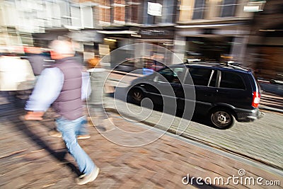 Driving car and walking people in the city