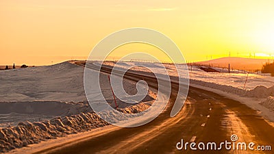 Driving towards Sun on winter road
