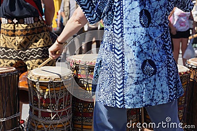 Drums played by women in brightly colored clothes