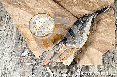 Dry fish with beer on wrapping paper