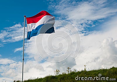 Dutch National Flag Waving In The Strong Wind