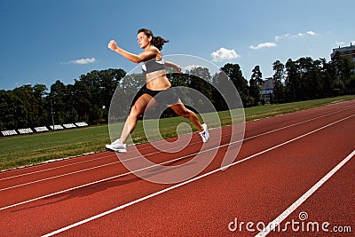 Dynamic image of a young woman running on a track