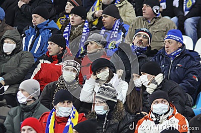 Dynamo Kiev fans wear protective masks