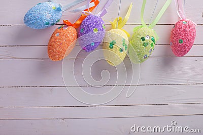 Colorful easter eggs on white wooden background. Easter background.