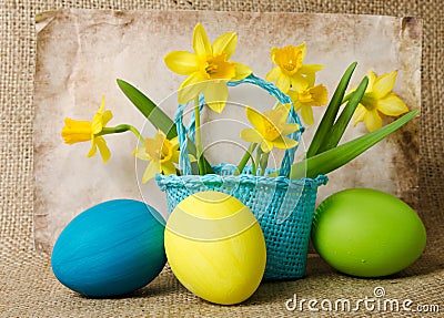 Easter eggs and daffodils in a basket