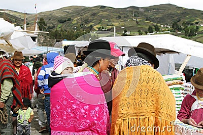 Ecuadorian ethnic people with indigenous clothes in a rural Saturday market in Zumbahua village, Ecuador.