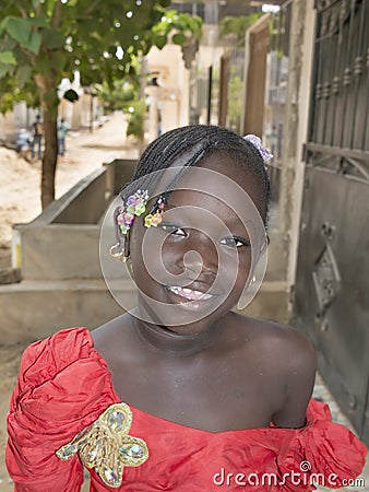 Editorial caption: M’Bao, Senegal, Africa – August 6, 2014: Child in the street on a feast day