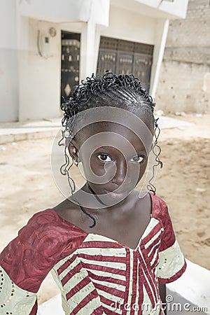 Editorial caption: M’Bao, Senegal, Africa – August 6, 2014: Child in the street on a feast day