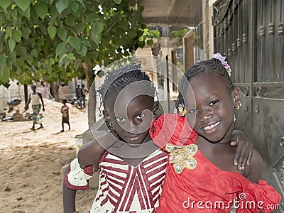 Editorial caption: M’BAO, SENEGAL, AFRICA – AUGUST 6, 2014- Two friends in the street on a feast day