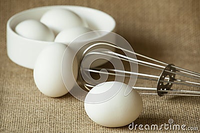 Eggs in a white bowl isoated on table mat.