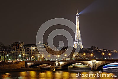 Eiffel Tower with night illumination and Pont des Invalides