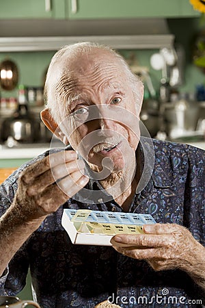 Elder Man with a Pill Case