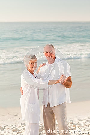 Elderly couple dancing on the beach