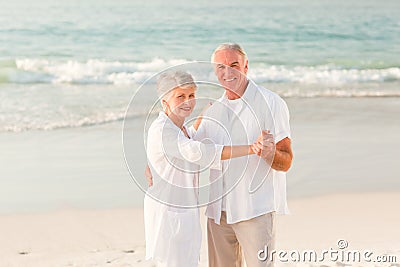 Elderly couple dancing on the beach