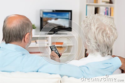 Elderly couple watching television