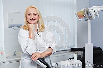 Elderly female dentist in dental practice