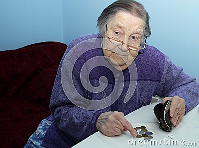 Elderly grandmother at the table thinks penny