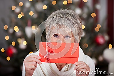Elderly lady with a red gift voucher