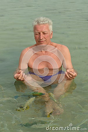 Elderly man meditating