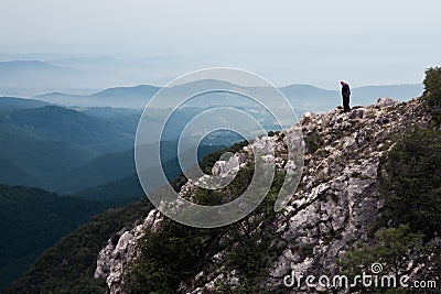 Elderly man standing on the edge of the cliff