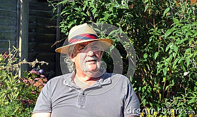 Elderly man with a straw hat.