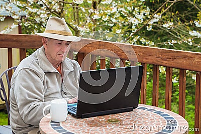 Elderly Man Working on Laptop Computer