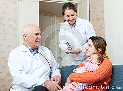 Elderly pediatrician talks to mother of young child