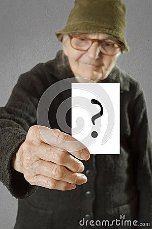 Elderly woman holding card with printed question mark.