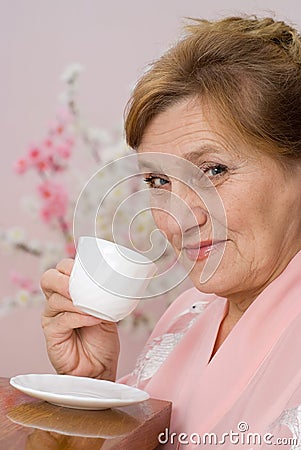 Elderly woman looks in the mirror