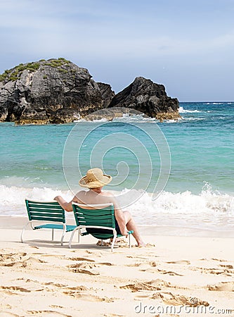 Elderly woman sitting at the beach