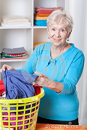 Elderly woman sorting laundry