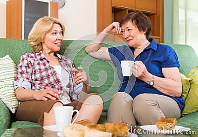 Elderly women at the table with tea