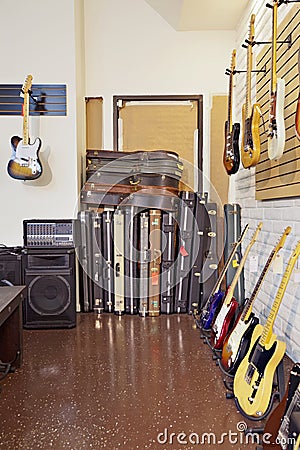 Electric guitars with guitar cases and amplifier in store