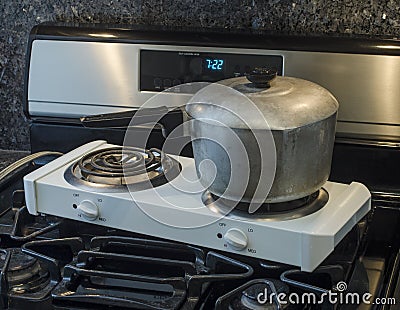 Electric hot plate on top of gas range