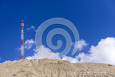 Electric power lines and pylon against blue sky