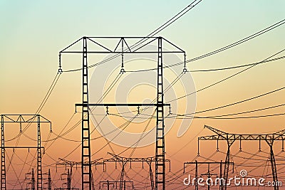 Electricity pylons on colorful evening sky