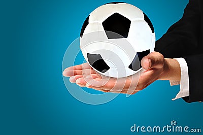 Elegant businessman holding a soccer ball