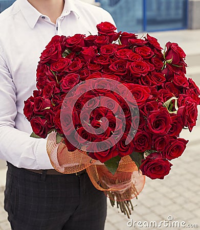 Elegant man with a bouquet of red roses