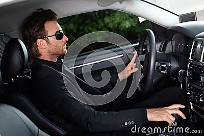 Elegant man driving a car
