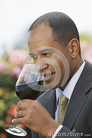 Elegant Man Smelling Red Wine