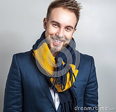 Elegant & Positive young handsome man in colorful scarf. Studio fashion portrait.