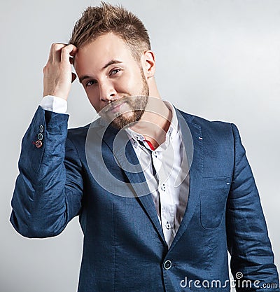 Elegant & Positive young handsome man in scarf. Studio fashion portrait.