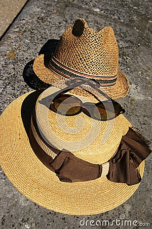 Elegant straw hat and designer glasses