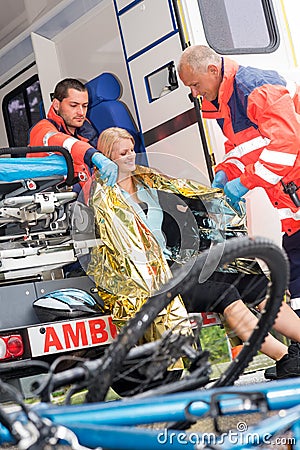 Emergency paramedics helping woman bike accident