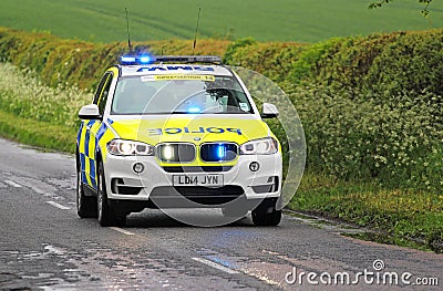 Emergency Police car with blue lights flashing.